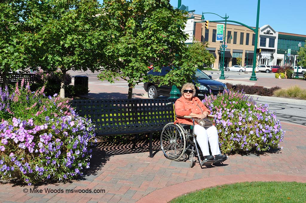 Marjorie Woods sitting on a bench in Clay Terrace outdoor shopping mall in 
 Carmel, Indiana