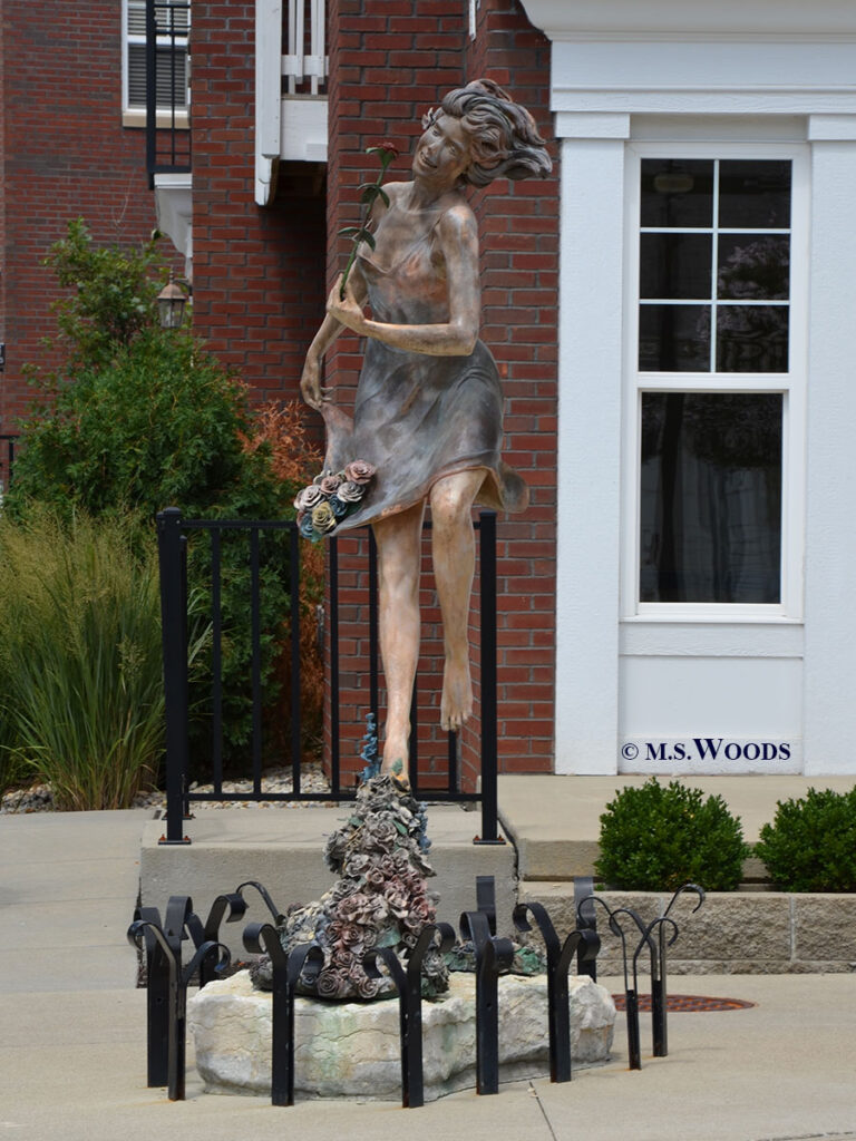 A whimsical piece entitled "Eternal Spring,” created by artist Jerry Joslin, depicts a dancing woman surrounded by flowers