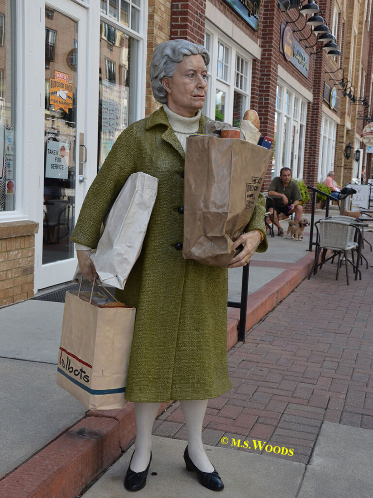 Holding Out is a statue of a woman holding shopping bags in Carmel, Indiana