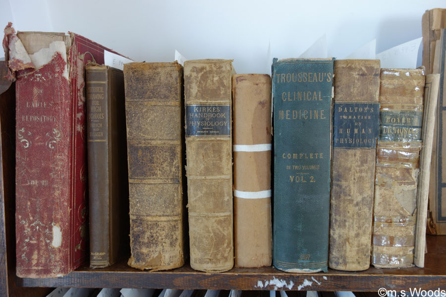 Old worn-out books on a shelf at the Academy Building and Museum in Mooresville, Indiana