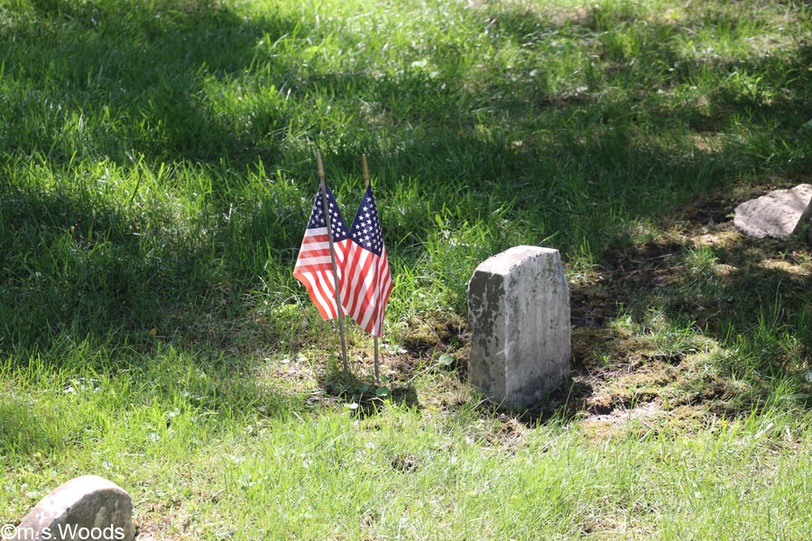 Gravestone with two American flags in the Anti-Slavery cemetery ASA Bales Park Westfield, Indiana