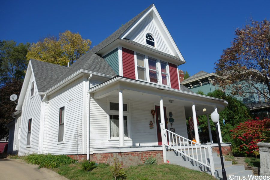 Historic house with white, red, and green wood siding in Greenfield, Indiana