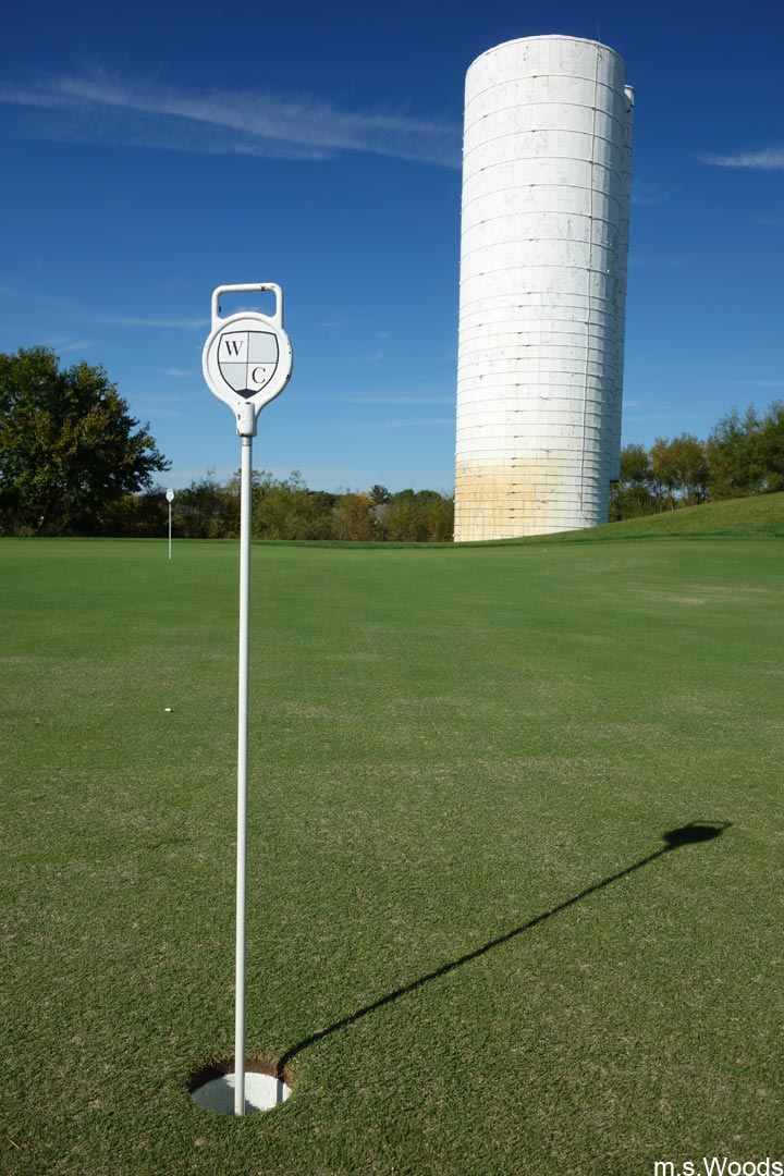 Pin and cup with an old silo in the background at the West Chase Golf Club in Brownsburg, Indiana